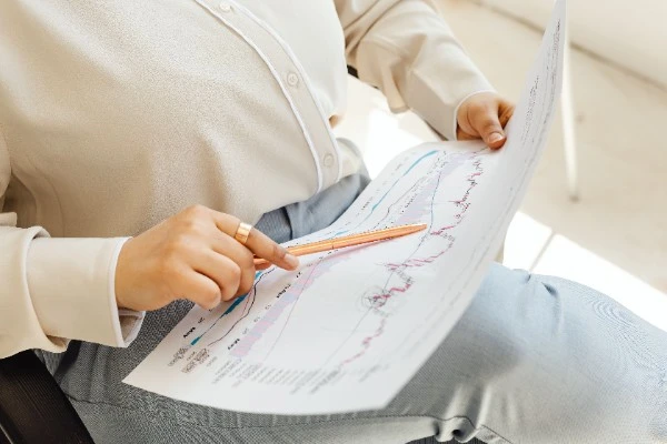 Company director in Singapore holding a pen and reviewing financial charts regarding insolvent trading and personal liability.